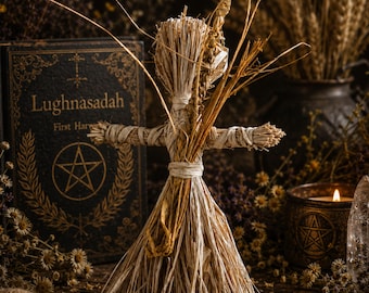 May include: A handcrafted straw doll figure made from dried wheat stalks, featuring a tied head, outstretched arms, and a flared skirt base. The doll is constructed from light tan natural fibers and includes a single upright wheat stalk accent.