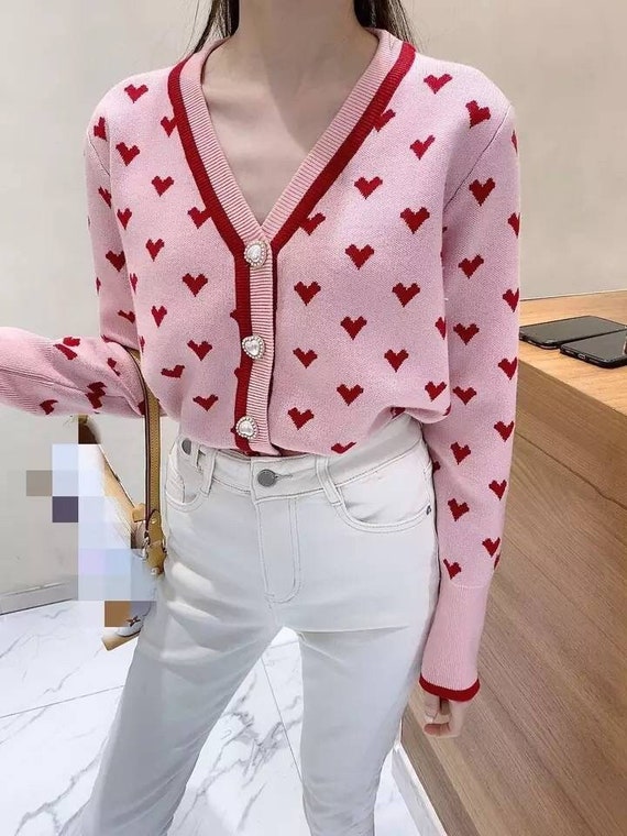 white sweater with pink hearts