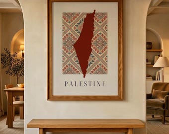 May include: A framed wall art print featuring a solid dark red map of Palestine centered over a cream-colored background with a geometric, multi-colored pattern of red, green, and blue diamonds. The word PALESTINE is printed in black below.