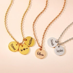 May include: Three necklaces in gold, rose gold, and silver with personalised name tags. The gold necklace has three tags: "Matthew", "Yvonne", and an arrow. The rose gold necklace has one tag that says "Noah". The silver necklace has one tag that says "Jayden" and another that says "Olivia".