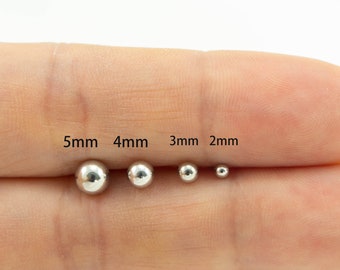 May include: Five silver ball beads in different sizes, 5mm, 4mm, 3mm, and 2mm, displayed on a finger.