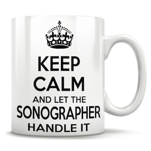 Puede incluir: Taza de cerámica blanca con un diseño negro que dice "Keep Calm and Let the Sonographer Handle It". El diseño también incluye una corona negra.