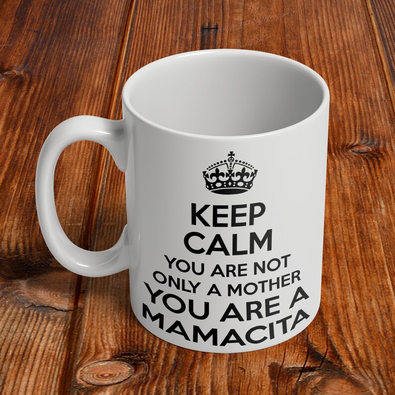 May include: White ceramic mug with a black crown and the text "Keep Calm You Are Not Only A Mother You Are A Mamacita".