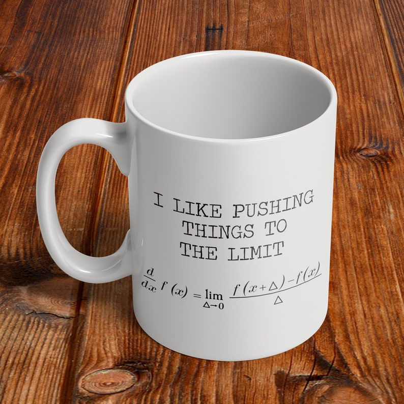 May include: White ceramic coffee mug with a black graphic that says "I like pushing things to the limit" and includes a mathematical formula for the derivative of a function.