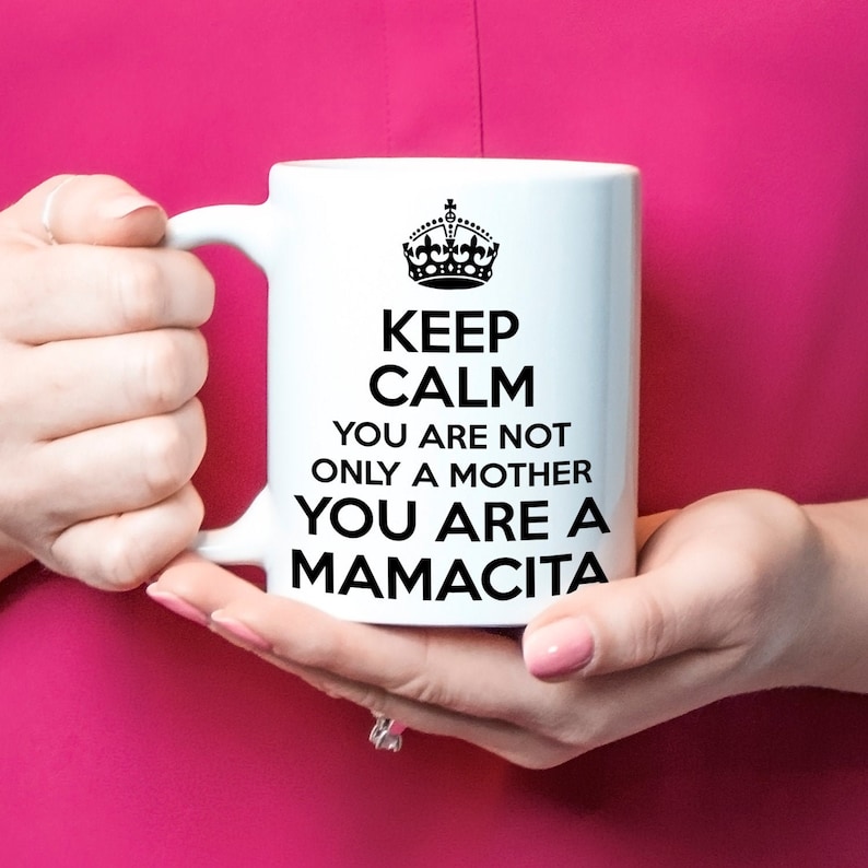 May include: White ceramic mug with a black crown and the text "Keep Calm You Are Not Only A Mother You Are A Mamacita".