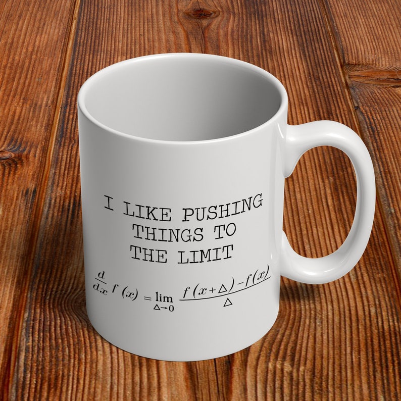 May include: White ceramic mug with a black graphic that says "I like pushing things to the limit" and includes a mathematical formula for the derivative of a function.