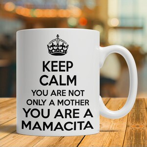 May include: White ceramic mug with a black crown and the text "Keep Calm You Are Not Only A Mother You Are A Mamacita".