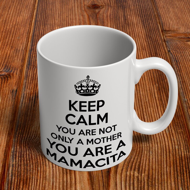 May include: White ceramic mug with a black crown and the text "Keep Calm You Are Not Only A Mother You Are A Mamacita".