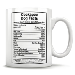 May include: White ceramic mug with a black and white graphic of a Cockapoo dog facts nutrition label. The label lists the dog's traits and characteristics, such as play time, cuddleability, and retrievability, with humorous percentages.