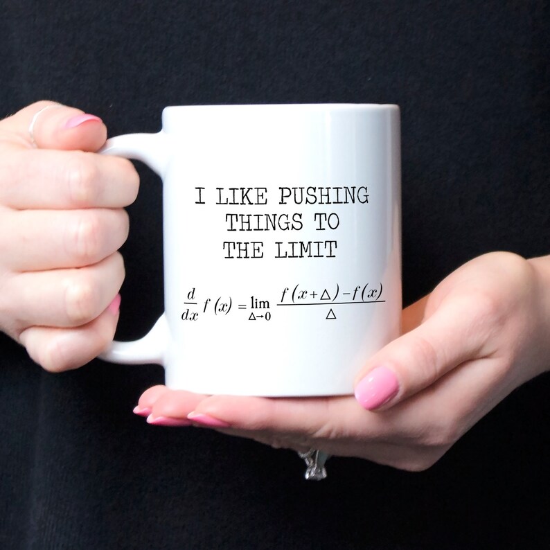 May include: White ceramic coffee mug with a black graphic that says "I like pushing things to the limit" and includes a mathematical formula for the derivative of a function.