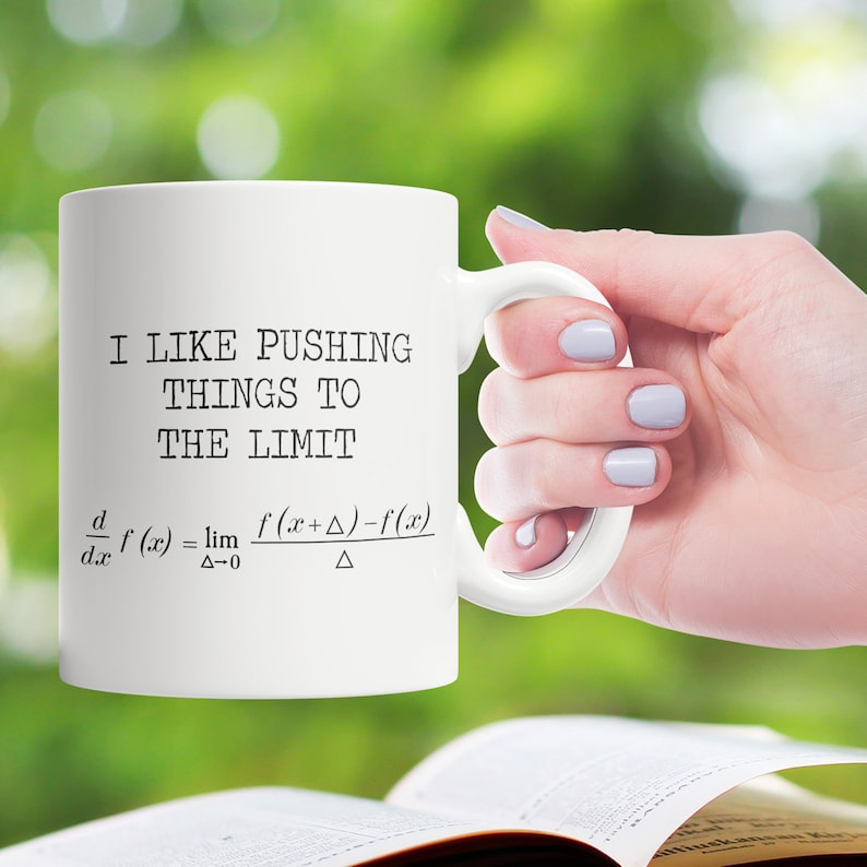 May include: White ceramic mug with a black graphic that says "I like pushing things to the limit" and a mathematical formula for the derivative of a function.