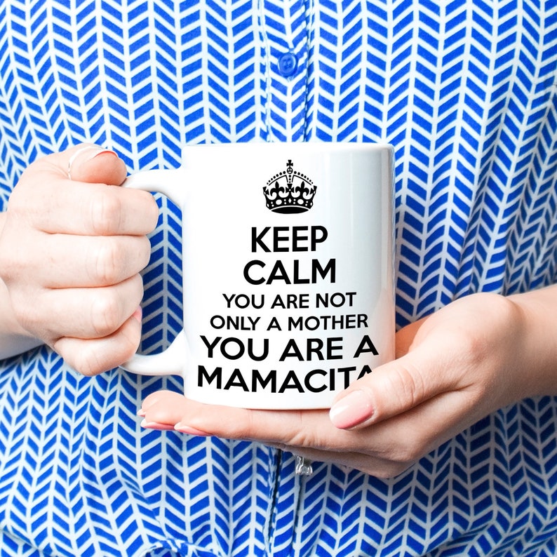 May include: White ceramic mug with a black crown and the text "Keep Calm You Are Not Only A Mother You Are A Mamacita".