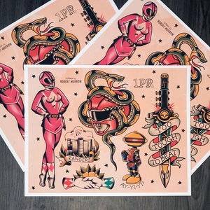 May include: A vintage-style illustration of a pink Power Ranger, a snake wrapped around a red Power Ranger helmet, a sword with the text "Too Tough To Beat", a robot with the text "Ay-Yi-Yi!" and the text "Rangers".