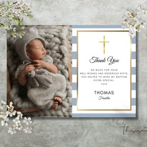 May include: A baptism thank you card with a photo of a sleeping baby in a gray knit outfit. The card features a gold cross and the words "Thank You" with a personalized message and name.