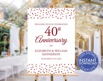 May include: A white sign with red hearts and the text "Welcome to our celebration 40th Anniversary of Elizabeth & William Matherson November 16th 20XX". The sign is on a wooden easel.