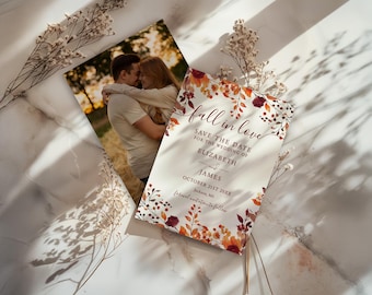 May include: Two wedding announcement cards. One features a couple embracing, the other has the text "fall in love" with floral accents. The text reads "Save the Date for the Wedding of Elizabeth and James, October 21st 20XX, Jackson, MS."