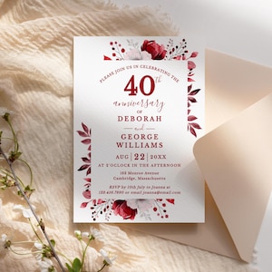 May include: A white anniversary invitation with burgundy floral accents and text. The invitation reads "40th anniversary of Deborah and George Williams" with the date August 22, 20XX. The invitation is placed on a beige background with a matching envelope.