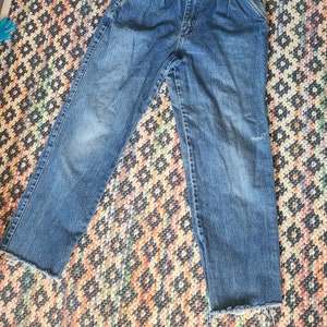 Vintage 1980s tapered high waisted pleated mom jeans, raw hem, size medium, retro, vintage denim, tapered leg, stonewash, distressed denim