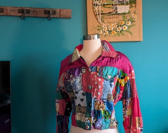 May include: A patchwork jacket with a vibrant mix of colors and patterns. The jacket features a magenta collar and sleeves, with a variety of fabric squares in different colors and designs. The jacket is displayed on a mannequin.
