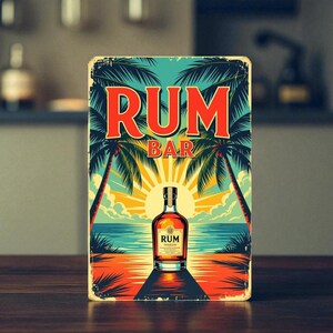 May include: Rectangular metal sign with a vintage design. The sign features the words "RUM BAR" in red, palm trees, a sunset, and a bottle of rum. The sign is set against a blurred background.