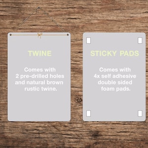May include: Two rectangular signs with text on a wooden background. One sign reads "TWINE" and includes natural brown twine. The other sign reads "STICKY PADS" and includes self-adhesive foam pads.