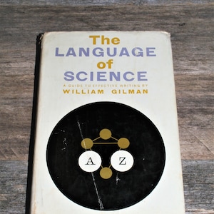 Puede incluir: Portada del libro "The Language of Science" con una ilustración en blanco y negro de un círculo con una A y una Z doradas en su interior y puntos dorados conectados por líneas.