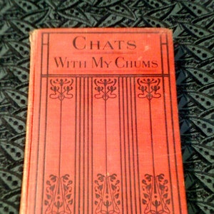 May include: A red hardcover book with the title "Chats With My Chums" and the author's name "D. Melville Simpson" printed on the front cover.