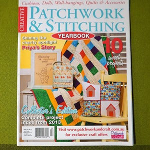 May include: A magazine cover for "Creative Patchwork & Stitching Yearbook" showcasing patchwork quilts, cushions, and embroidery. The cover advertises "10 sweet projects" and "Priya's Story". It's a collector's edition with a project index from 2013. The magazine is on a green surface.