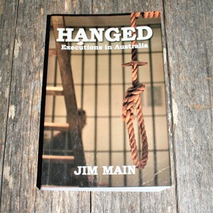 May include: A book titled "Hanged: Executions in Australia" by Jim Main. The cover features a close-up of a noose hanging from a metal hook.