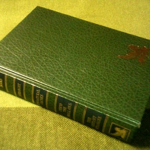 May include: A green leather-bound book with gold lettering on the spine. The title is "Central Places" and the author is "Christaller Walter".