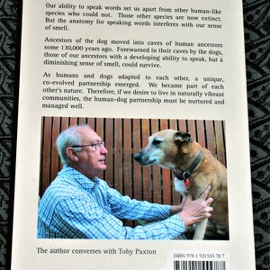 May include: A book cover with a photo of a man and a dog. The book title is "Sensational...A profound re-appraisal of human evolution with dogs". The text on the cover describes the relationship between humans and dogs. The author is Toby Paxton. The ISBN is 978 1 921555 78 7.