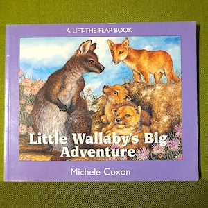 May include: A children's lift-the-flap book titled "Little Wallaby's Big Adventure" with illustrations of a wallaby, dingoes, and a floral background. The cover is purple with the author's name, Michele Coxon, at the bottom.