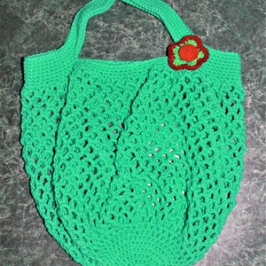May include: A green crocheted mesh bag with a red and green flower embellishment.