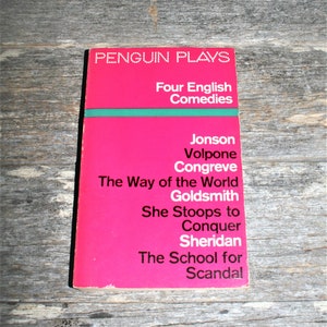 May include: A pink Penguin Plays paperback book with the title "Four English Comedies" and a list of plays including "Volpone", "The Way of the World", "She Stoops to Conquer", and "The School for Scandal".