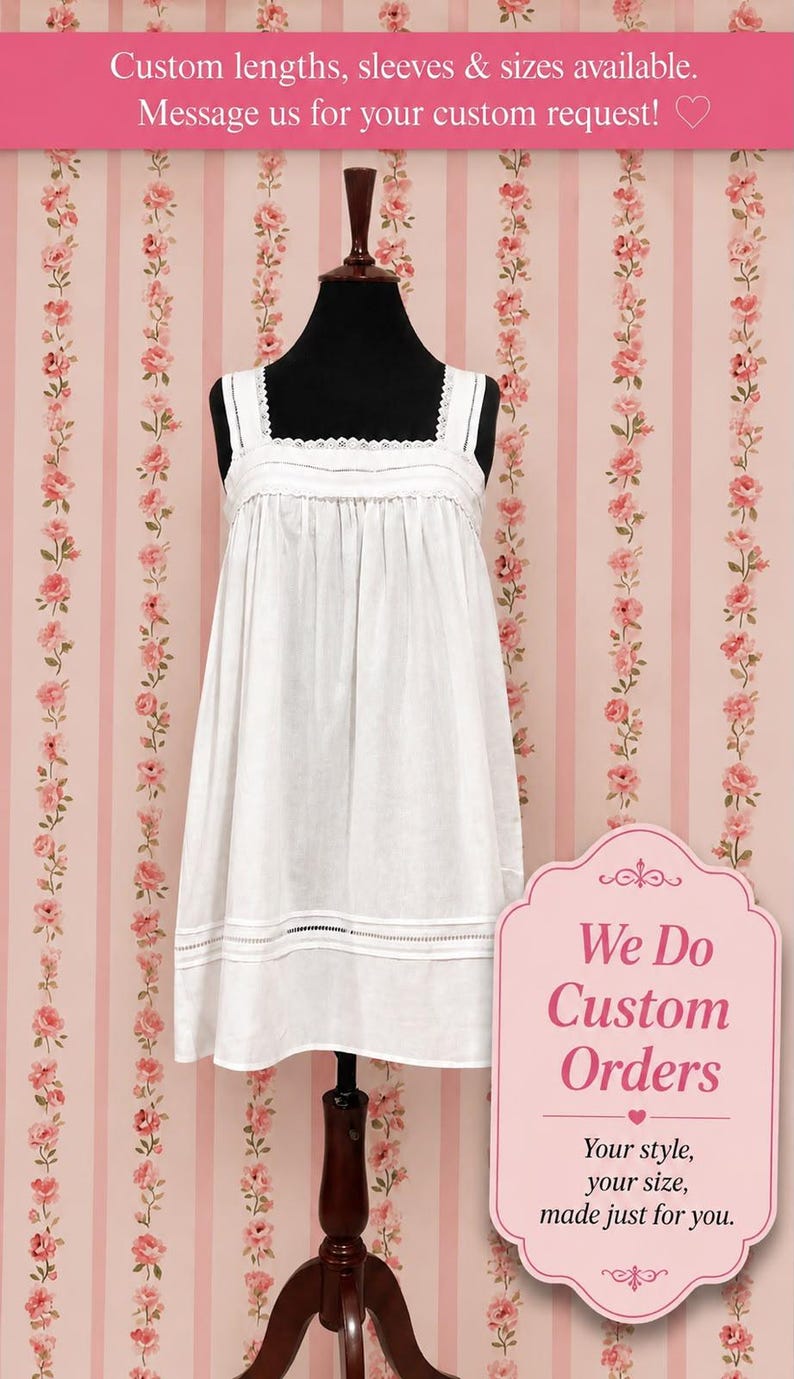 May include: A white sleeveless dress featuring a square neckline with delicate lace trim, a gathered bodice, and horizontal pintuck detailing near the hem. The dress is displayed on a black mannequin against a pink and white floral striped background.