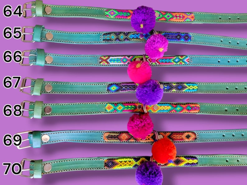 May include: Seven teal leather collars numbered 64 through 70, each featuring a central woven textile strip with geometric patterns in various colors and a single hanging pom-pom in purple, pink, or orange attached to the center.
