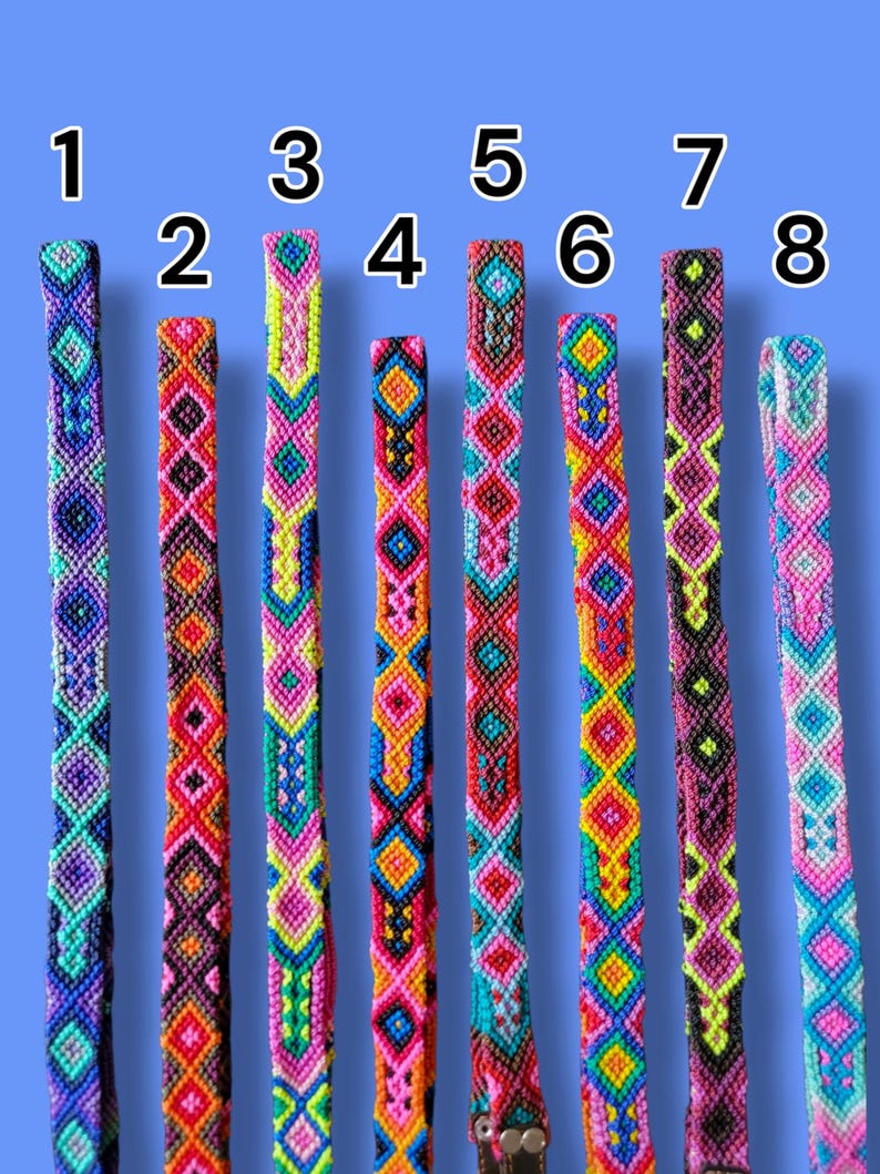 May include: Eight woven friendship bracelets arranged vertically and numbered one through eight. Each bracelet features a unique, intricate geometric pattern created with vibrant, multi-colored thread including shades of pink, blue, yellow, and black.