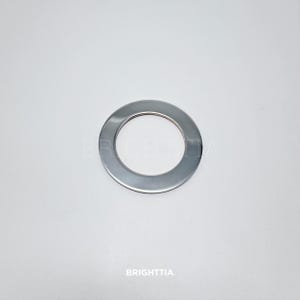 May include: A silver metal ring with a smooth, polished finish. The ring is about 2 inches in diameter.