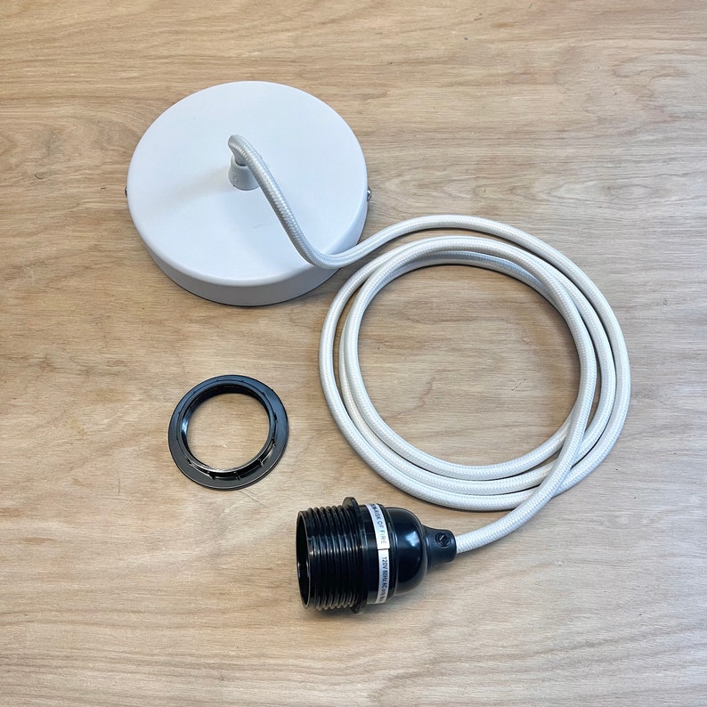 May include: White ceiling rose, white fabric covered cord, black lamp holder and a black metal ceiling plate.