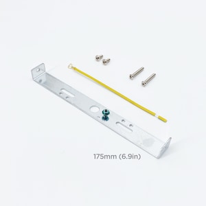 May include: A silver metal mounting bracket with four screw holes and a yellow wire attached. The bracket is 6.9 inches long and includes four screws.