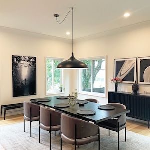 Black Easy Hook used to swag large black shade pendant to the center of dining table. Ceiling electrical junction box is not centered.