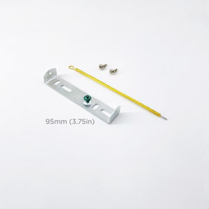 May include: A silver metal mounting bracket with two screw holes and a green screw. The bracket is 3.75 inches long. Two silver screws are included.