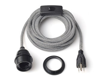 May include: Black and white zig-zag patterned electrical cord with a black lamp holder, a black switch, and a black plug. A black ring is also included. The cord is coiled and ready for use.