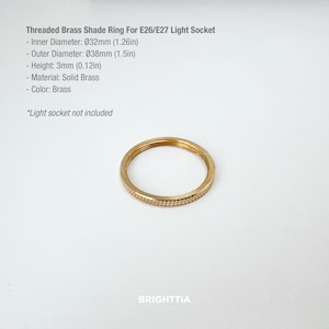 May include: A brass shade ring for E26/E27 light sockets. The ring has an outer diameter of 1.5 inches and a height of 0.12 inches. The material is solid brass and the color is brass. The text on the image says "BRIGHTTIA."