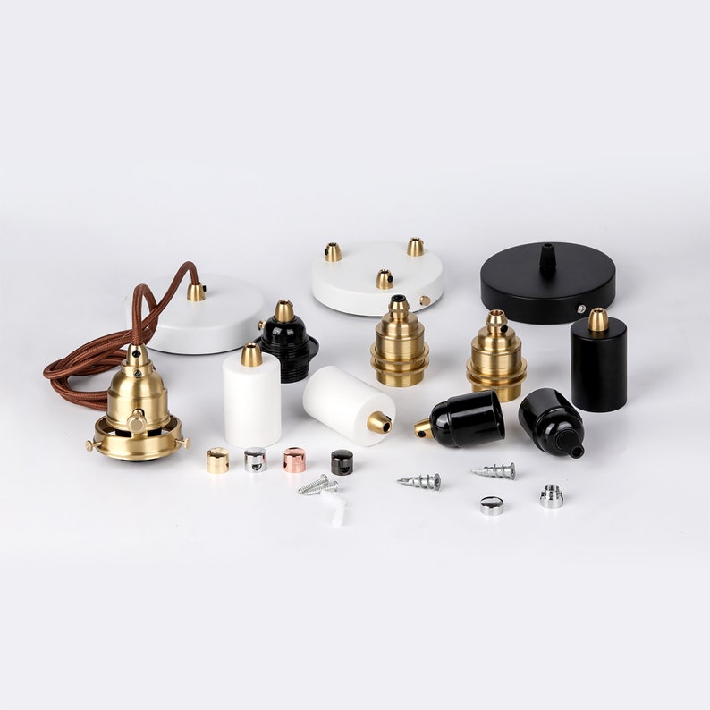 May include: Assortment of white, black, and brass electrical components for hanging light fixtures. The components include ceiling plates, cord sets, and lamp holders.