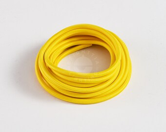 May include: A coil of bright yellow electrical cord, ideal for adding a splash of colour to your home decor projects.