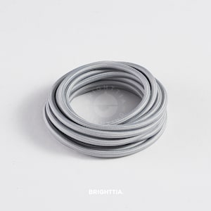May include: A coil of silver-colored electrical cord, perfect for adding a modern touch to your home decor projects.