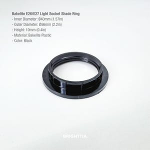 May include: Black Bakelite E26/E27 light socket shade ring. The inner diameter is 1.57 inches, outer diameter is 2.2 inches, and height is 0.4 inches. The material is Bakelite plastic.