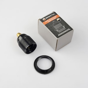 May include: Black light bulb socket with a brass screw terminal and a black plastic base. The socket is packaged in a box with the text "BRIGHTTIA. LIGHT BULB SOCKET/ LAMP HOLDER SHADE READY BAKELITE SOCKET WITH BRASS CORD SRIP (BA-LAG)"