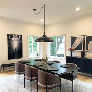 Black Easy Hook used to swag large black shade pendant to the center of dining table. Ceiling electrical junction box is not centered.